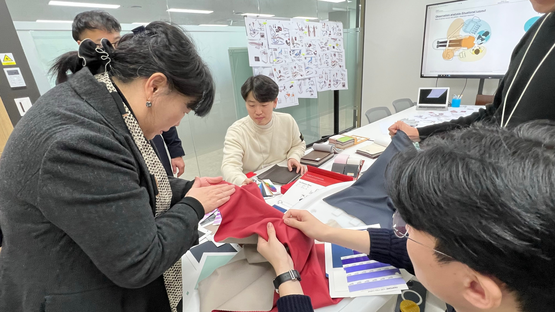Kim Jin (left), director of Osstem Implant’s design research and development centre, examining the material of the dental chair unit seat with her team members. After developing the seat colour of the K5 dental chair unit, the team searched all over South Korea for a production plant that could perfectly process the fabric as designed.